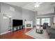 Bright living room with a fireplace, ample seating, hardwood floors, and a ceiling fan at 3625 Ennfield Ln, Duluth, GA 30096