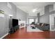 Open living room featuring hardwood floors, fireplace, ceiling fan, and plenty of natural light at 3625 Ennfield Ln, Duluth, GA 30096