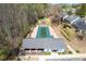 Aerial view of the community pool, clubhouse and play area surrounded by trees at 3625 Ennfield Ln, Duluth, GA 30096