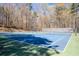 Community tennis court surrounded by mature trees at 3625 Ennfield Ln, Duluth, GA 30096