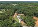Overhead view of a beautiful property surrounded by lush greenery and mature trees at 779 Hicks Rd, Canton, GA 30115