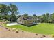 Rear view of a two-story home with a large covered patio and spacious backyard at 779 Hicks Rd, Canton, GA 30115