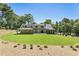 Expansive backyard featuring a lush lawn, mature trees, and covered patio at 779 Hicks Rd, Canton, GA 30115