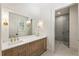 Bright bathroom featuring marble floors, double vanity, and glass enclosed shower at 779 Hicks Rd, Canton, GA 30115