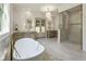 Bright bathroom featuring marble floors, double vanity, a glass enclosed shower, and backyard access at 779 Hicks Rd, Canton, GA 30115
