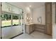 Bright bathroom featuring marble floors, vanity, and backyard access at 779 Hicks Rd, Canton, GA 30115