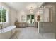 Bright bathroom featuring marble floors, double vanity, and a glass enclosed shower at 779 Hicks Rd, Canton, GA 30115