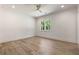 Light-filled bedroom with hardwood floors and white trim throughout at 779 Hicks Rd, Canton, GA 30115