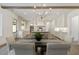 Sunlit dining room has hardwood floors, decorative light fixture and opens into the kitchen area at 779 Hicks Rd, Canton, GA 30115