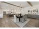 Bright, open dining room features hardwood floors, wooden beam ceiling, and flows into the kitchen at 779 Hicks Rd, Canton, GA 30115