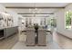 Open concept dining room featuring hardwood floors and modern light fixture flows into living space at 779 Hicks Rd, Canton, GA 30115