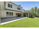 Rear exterior view of a home, featuring a covered patio, screened-in porch, and landscaped yard at 779 Hicks Rd, Canton, GA 30115