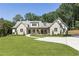 Beautiful stone home with a manicured lawn, large driveway, and inviting front porch at 779 Hicks Rd, Canton, GA 30115