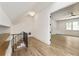 Hallway with hardwood floors and iron railing, leading to another room at 779 Hicks Rd, Canton, GA 30115