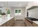 Bright kitchen featuring stainless appliances, white backsplash, and a view of the backyard at 779 Hicks Rd, Canton, GA 30115