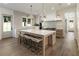 Open kitchen with large island, stainless appliances, pendant lights, and access to backyard at 779 Hicks Rd, Canton, GA 30115