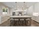 Spacious kitchen with large island, white countertops, pendant lighting, and stainless steel appliances at 779 Hicks Rd, Canton, GA 30115