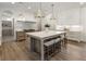 Open concept kitchen with island and seating, featuring stainless appliances and white cabinetry at 779 Hicks Rd, Canton, GA 30115