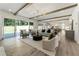 Bright and open living room with hardwood floors, beamed ceilings, and a sliding glass door at 779 Hicks Rd, Canton, GA 30115
