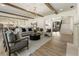 Spacious open-concept living room with hardwood floors, beamed ceilings, and stylish furnishings at 779 Hicks Rd, Canton, GA 30115