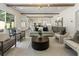 Open-concept living room with hardwood floors, modern furniture, and ample natural light at 779 Hicks Rd, Canton, GA 30115