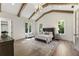Elegant main bedroom with vaulted ceilings, exposed beams, and hardwood floors at 779 Hicks Rd, Canton, GA 30115