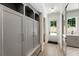 Mudroom features custom built-ins, gray cabinets, and access to the outside at 779 Hicks Rd, Canton, GA 30115