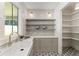Well-lit pantry featuring built-in shelving and storage, stone backsplash, and stainless faucet at 779 Hicks Rd, Canton, GA 30115