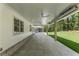 Spacious covered patio features a tile floor, ceiling fans, and wooded backyard views at 779 Hicks Rd, Canton, GA 30115