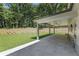 A covered patio offers a serene outdoor space with a lush green lawn at 779 Hicks Rd, Canton, GA 30115
