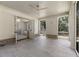 Back patio with stone floors, wainscotting, ceiling fan, and bathroom access at 779 Hicks Rd, Canton, GA 30115