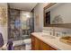 Bathroom features a custom glass shower with beautiful tile and a stylish vanity at 1600 Brisbane Drive, Dacula, GA 30019