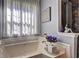 Relaxing bathroom with a soaking tub and elegant decorative touches at 1600 Brisbane Drive, Dacula, GA 30019