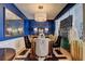 Sophisticated dining room featuring a round table, stylish chairs, wainscoting, and a decorative mirror that complements the decor at 1600 Brisbane Drive, Dacula, GA 30019