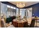 Stylish dining room with a round table, elegant chairs, statement lighting, and access to other living spaces in the home at 1600 Brisbane Drive, Dacula, GA 30019