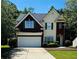 Charming two-story home with a two-car garage, beautiful landscaping and traditional architectural details at 1600 Brisbane Drive, Dacula, GA 30019