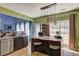 Bright, modern kitchen showcasing stainless steel appliances, wood cabinetry, a kitchen island, and a view to the backyard at 1600 Brisbane Drive, Dacula, GA 30019