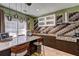 Well-appointed kitchen boasting stainless steel appliances, wood cabinetry, a tile backsplash, and an island with bar seating at 1600 Brisbane Drive, Dacula, GA 30019