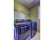 Modern laundry room with front-load washer and dryer, complemented by wire shelving for efficient storage at 1600 Brisbane Drive, Dacula, GA 30019