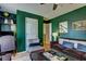 Cozy living room featuring bold green walls, a decorative sofa, and unique accents, providing a comfortable space at 1600 Brisbane Drive, Dacula, GA 30019