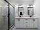 Modern bathroom with double vanity, sleek fixtures, glass enclosed shower and tiled flooring at 270 Harmony Woods Dr, Dallas, GA 30157