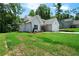 White board and batten home with an attached garage, surrounded by a bright green lawn at 270 Harmony Woods Dr, Dallas, GA 30157