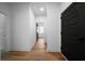 Bright hallway with wood floors, crisp white walls, and modern black doors at 270 Harmony Woods Dr, Dallas, GA 30157