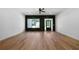 Spacious living room with hardwood flooring, black accent wall and abundant natural light at 270 Harmony Woods Dr, Dallas, GA 30157