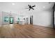 Bright, open-concept living room and kitchen area with hardwood floors and stylish light fixtures at 270 Harmony Woods Dr, Dallas, GA 30157
