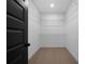 Empty walk-in closet with wire shelving and carpeted floor ready for storage solutions at 270 Harmony Woods Dr, Dallas, GA 30157