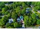 Aerial view of the beautiful home with a backyard pool surrounded by mature trees in a lush neighborhood at 2882 Clary Hill Ne Dr, Roswell, GA 30075