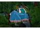 Stunning aerial view of a brick home featuring a beautiful pool and lush landscaping at 2882 Clary Hill Ne Dr, Roswell, GA 30075