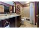 Bathroom featuring dark wood cabinets, granite countertops, shower and tub at 2882 Clary Hill Ne Dr, Roswell, GA 30075