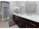 Bathroom features double sink vanity with granite countertop and a view of the shower area at 2882 Clary Hill Ne Dr, Roswell, GA 30075